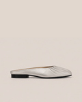 A single metallic silver flat mule slipper with a gathered, pleated crown and a low black heel, shown in profile against a solid beige background.